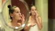 Video: Woman applying facial mask in the bathroom Woman applying facial mask in the bathroom