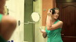 Video: Young beautiful woman applying makeup on her face with brush Young beautiful woman applying makeup on her face with brush