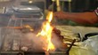 Hawker Grilling Satay over Barbecue Pit Open Flames in Singapore