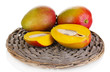 Ripe appetizing mango on wicker cradle isolated on white
