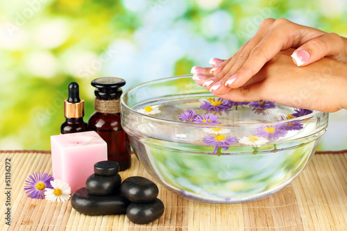 Photo: spa treatments for female hands, on bright green background spa treatments for female hands, on bright green background