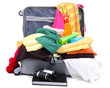 Open silver suitcase with clothing isolated on white
