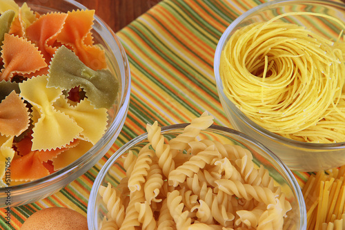 Photo: Different types of pasta on striped tablecloth Different types of pasta on striped tablecloth