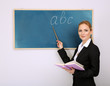 Portrait of teacher woman near chalkboard in classroom