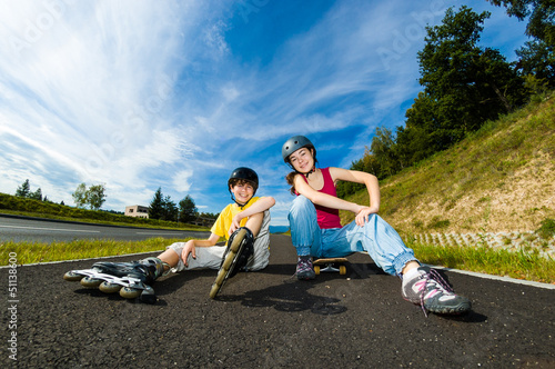 Photo: Active young people - rollerblading, skateboarding Active young people - rollerblading, skateboarding