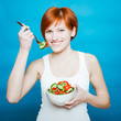 Photo: young happy woman eating salad young happy woman eating salad