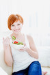 Photo: young happy woman eating salad young happy woman eating salad