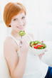Photo: young happy woman eating salad young happy woman eating salad