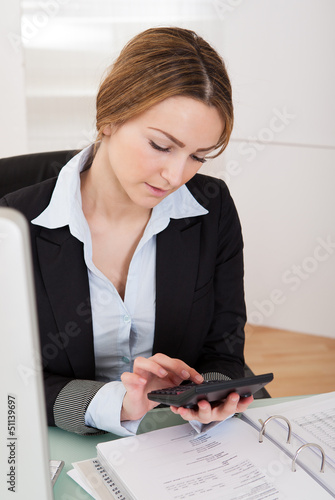 Photo: Businesswoman Working In Office Businesswoman Working In Office