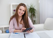 Young Woman Calculating Bills