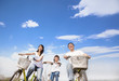 Photo: happy family riding bicycle with cloud background happy family riding bicycle with cloud background