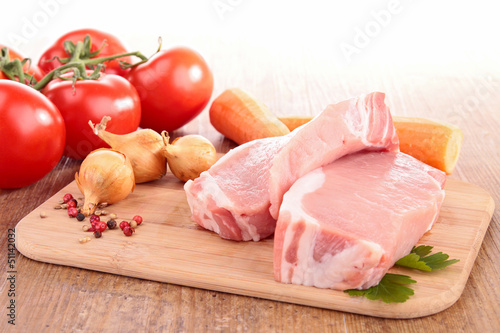 Photo: raw meat on board with ingredients raw meat on board with ingredients