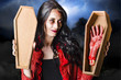 Female Halloween zombie holding undead hand
