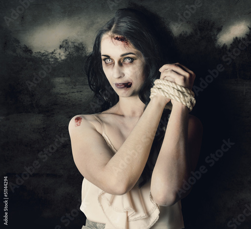 Photo: Dark horror scene of an evil zombie woman tied up Dark horror scene of an evil zombie woman tied up