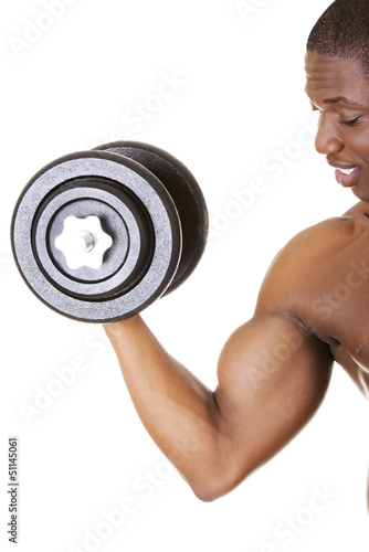 Photo: Muscular young man lifting weights Muscular young man lifting weights