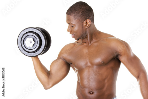 Photo: Muscular young man lifting weights Muscular young man lifting weights