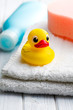 yellow bath duck on white towel
