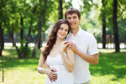 Photo: Young love Couple smiling under blue sky Young love Couple smiling under blue sky