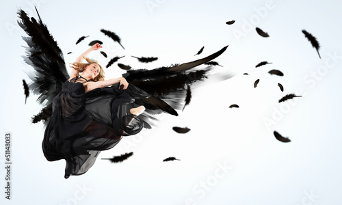 Photo: Woman floating on dark wings Woman floating on dark wings