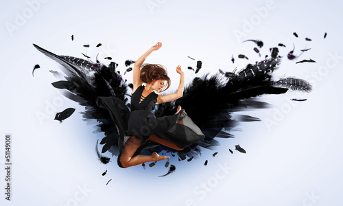 Photo: Woman floating on dark wings Woman floating on dark wings