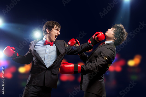 Photo: Two young businessman boxing Two young businessman boxing