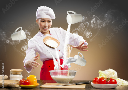 Photo: Asian female cooking with magic Asian female cooking with magic