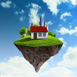 A piece of land in the air with house and tree.
