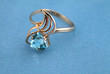 Golden jewelry ring with blue topaz