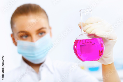 Photo: Young female scientist working in laboratory Young female scientist working in laboratory