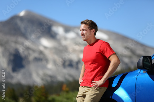 Photo: Car and driver man in beautiful mountain landscape Car and driver man in beautiful mountain landscape