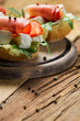 Photo: Fresh sandwiches on a old wooden cutting board background 3 Fresh sandwiches on a old wooden cutting board background 3