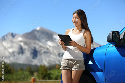 Photo: Traveler woman using tablet on Yosemite road trip Traveler woman using tablet on Yosemite road trip