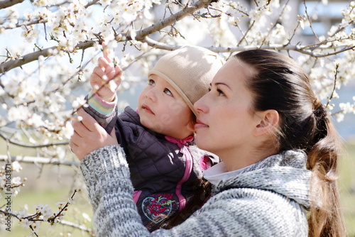 Photo: woman with child near the blossom tree woman with child near the blossom tree