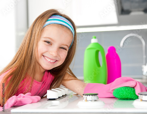 Photo: girl make cleaning in the kitchen girl make cleaning in the kitchen