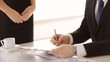 man signing a contract