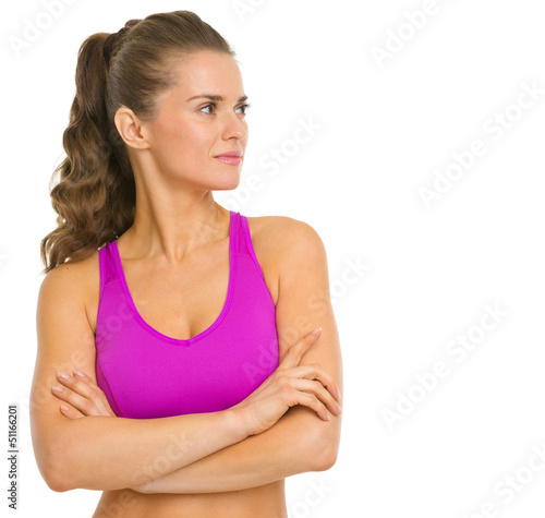 Photo: Portrait of fitness young woman looking on copy space Portrait of fitness young woman looking on copy space