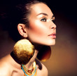 Fashion Woman Portrait. Golden Jewels. Trendy Makeup