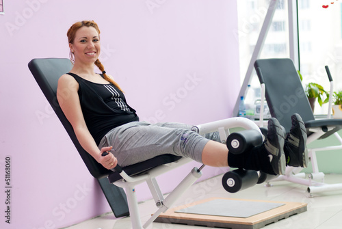 Photo: Cute young happy smiling woman going fitness exercesing Cute young happy smiling woman going fitness exercesing