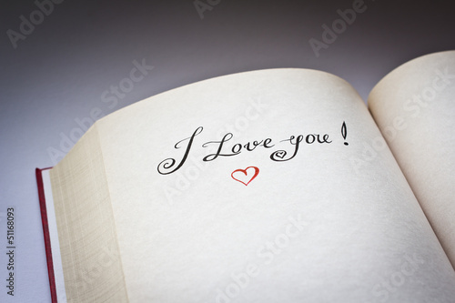 Photo: I love you words in the open book with grey background I love you words in the open book with grey background