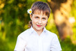 Photo: Smiling boy outdoor portrait in the park Smiling boy outdoor portrait in the park