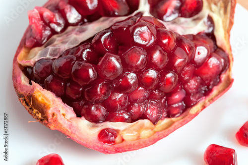 Photo: The cut pomegranate and grains on a plate The cut pomegranate and grains on a plate