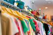 Variety of clothes hanging on rack