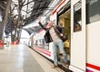 Happy middle-aged traveler meeting someone 