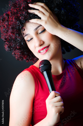 Photo: Female performer at disco with mic Female performer at disco with mic