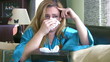 Crying woman on sofa