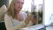 Woman confirming credit card data for e-commerce.