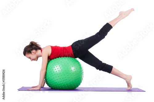 Photo: Young woman with ball exercising on white Young woman with ball exercising on white