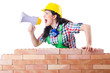 Woman with louspeaker near brick wall
