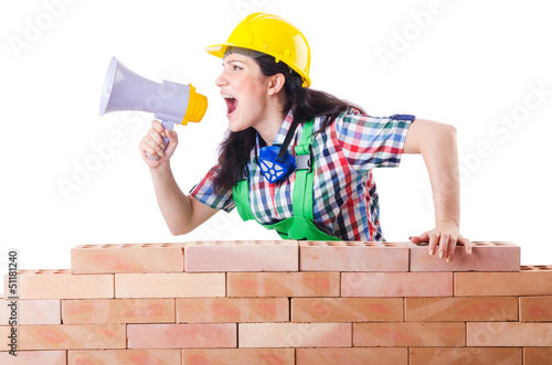 Photo: Woman with louspeaker near brick wall Woman with louspeaker near brick wall