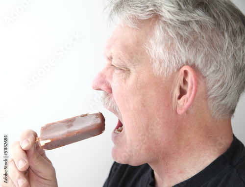 Photo: senior man with ice cream bar profile view senior man with ice cream bar profile view